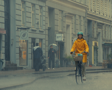 Vrouw op fiets met Arla Jörd producten